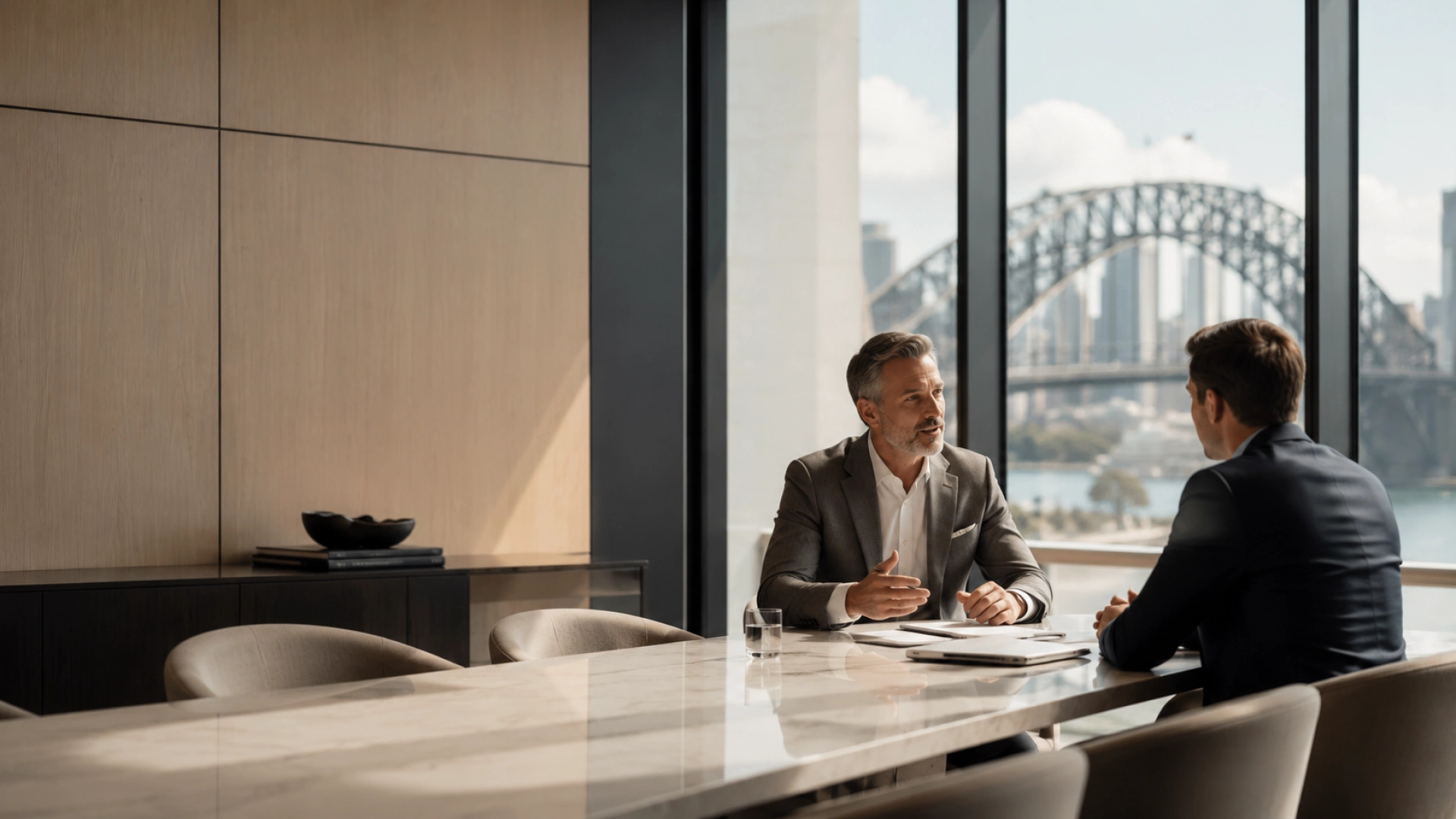 Glass-walled meeting room at Ashworth Merrill's Amsterdam office, wood conference table and morning light